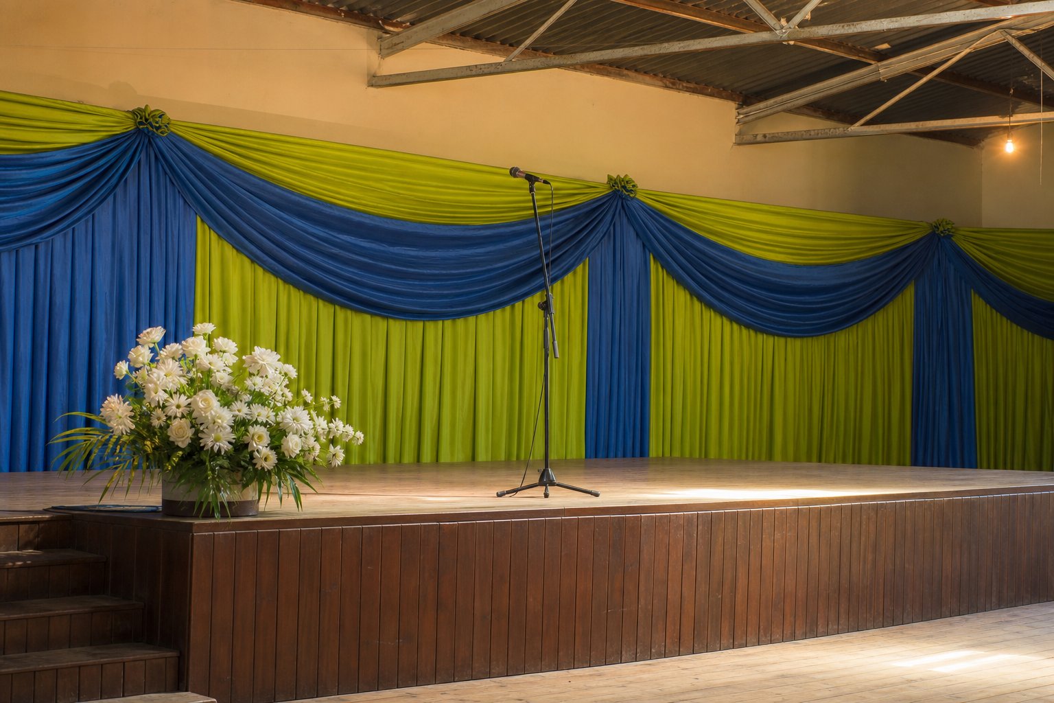 Prepared worship stage with blue and green drapes